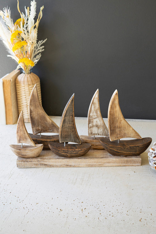 FIVE WOODEN SAIL BOATS ON A BASE